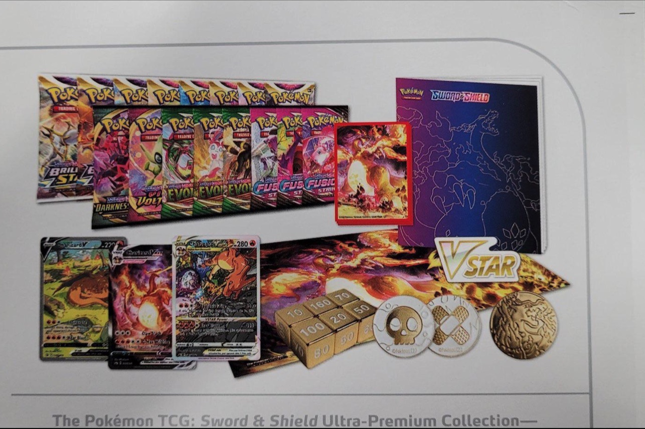 A printed document showing the box contents of the Ultra-Premium Collection - Charizard
